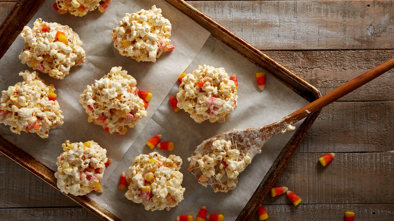 Candy corn popcorn balls on baking sheet