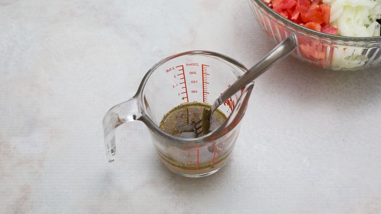 Vinaigrette and fork in measuring cup