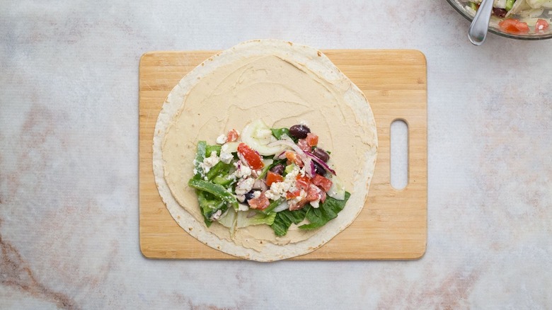 hummus-coated tortilla topped with Greek salad