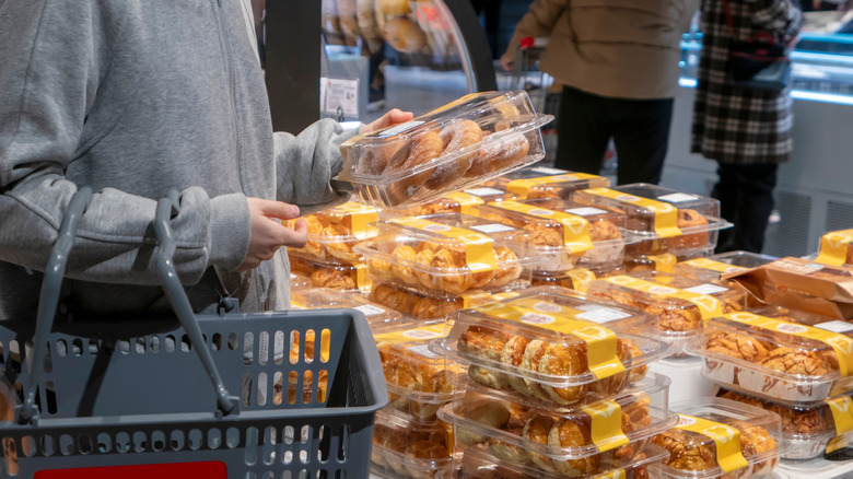 shopper looking at baked goods in grocery store bakery