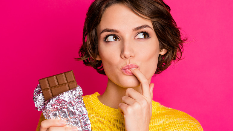 Woman licking chocolate off finger