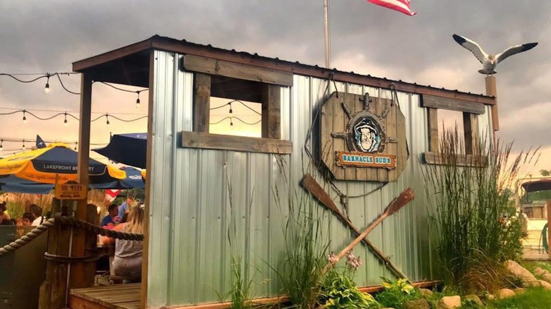 Exterior of Barnacle Bud's restaurant with people seated outside