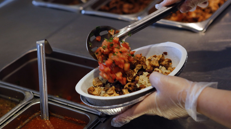 preparing Chipotle bowl