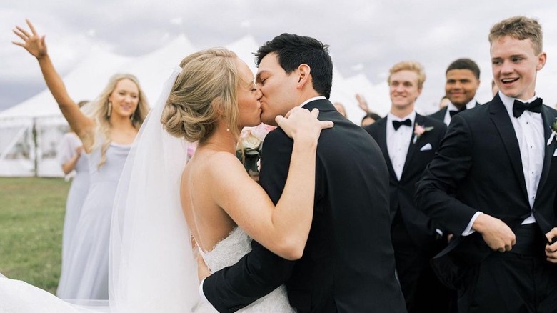 Alex Drummond and Mauricio Scott kiss on wedding day