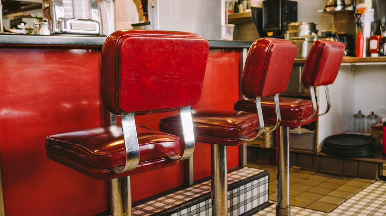 Old-fashioned diner with red swivel stools