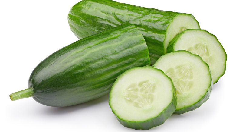 Cucumber cut in half and slices of cucumber