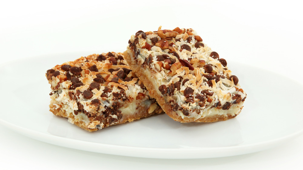 Magic cookie bars on a white plate