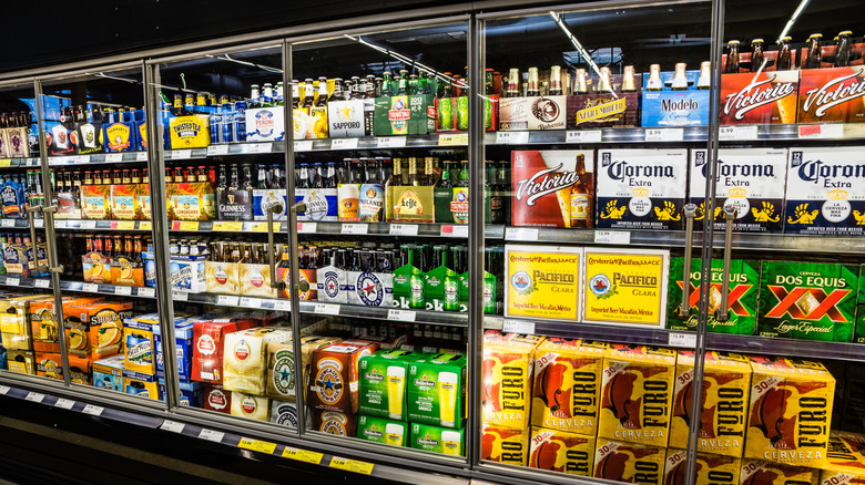 Refrigerated six-packs and cases of beer in store
