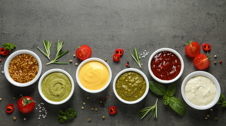 Several condiments in tiny bowls