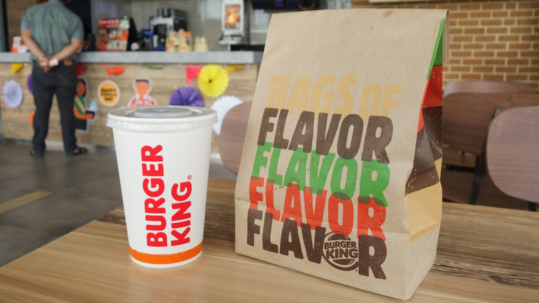 Burger King bag and cup on table