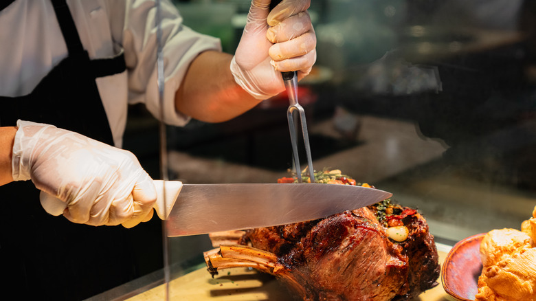 chef slicing into prime rib in restaurant