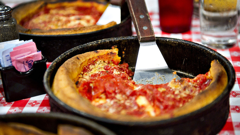 Deep dish pizza in a black pan