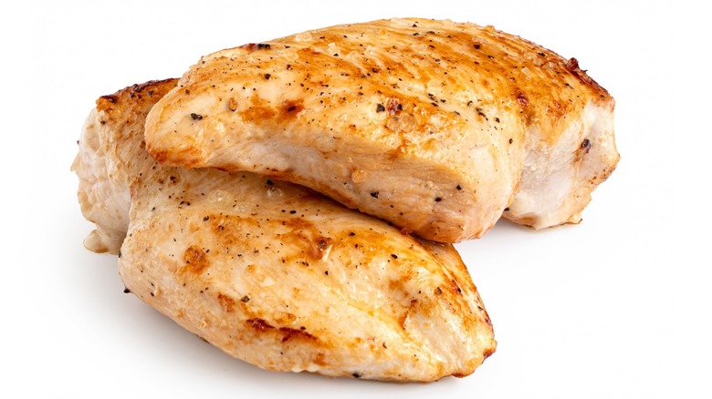 Cooked chicken breast on white background