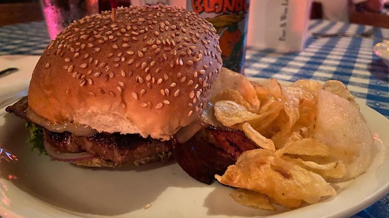 Burger on plate with sesame bun