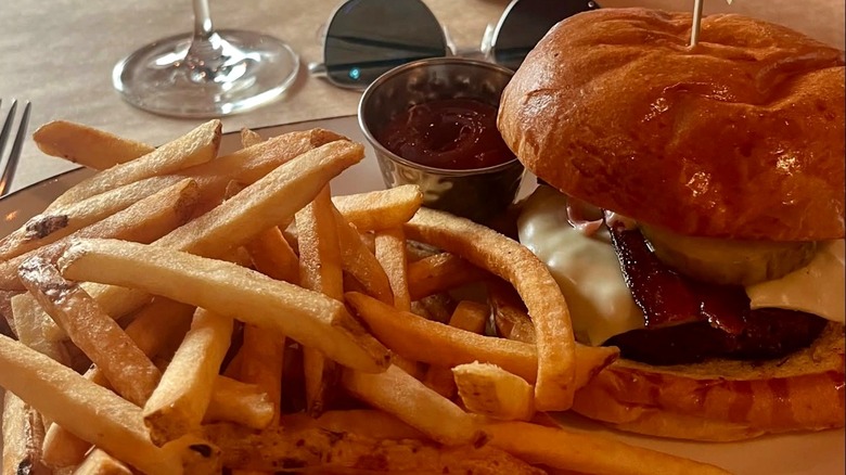 Burger and fries plated with ketchup