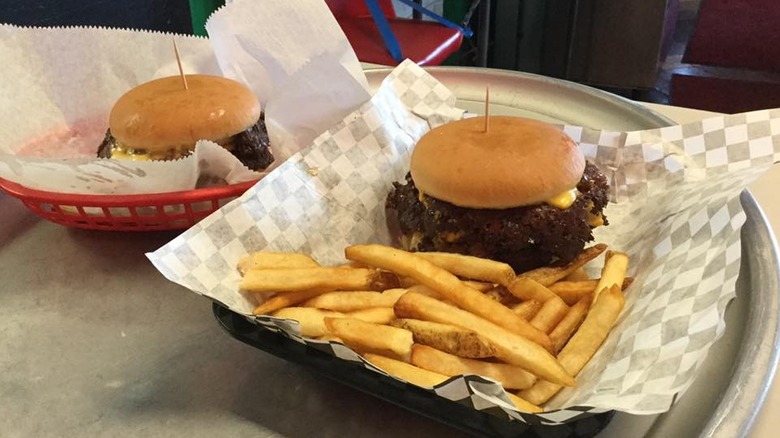 Burgers in plastic baskets on tray
