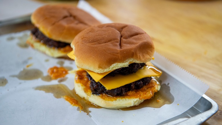 Double cheeseburgers on a pan