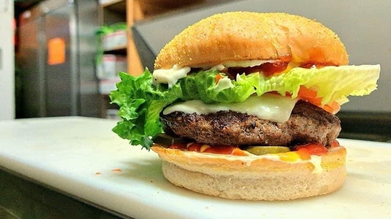 A burger on kitchen prep line