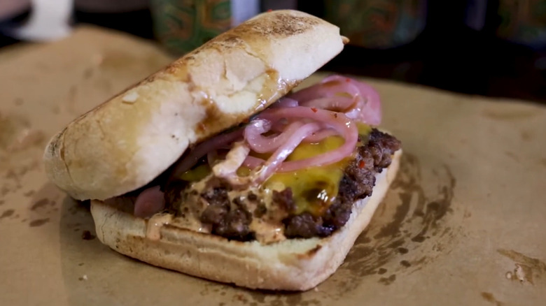 Greasy burger on butcher paper