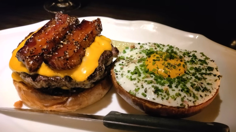 Burger with a pickle and knife