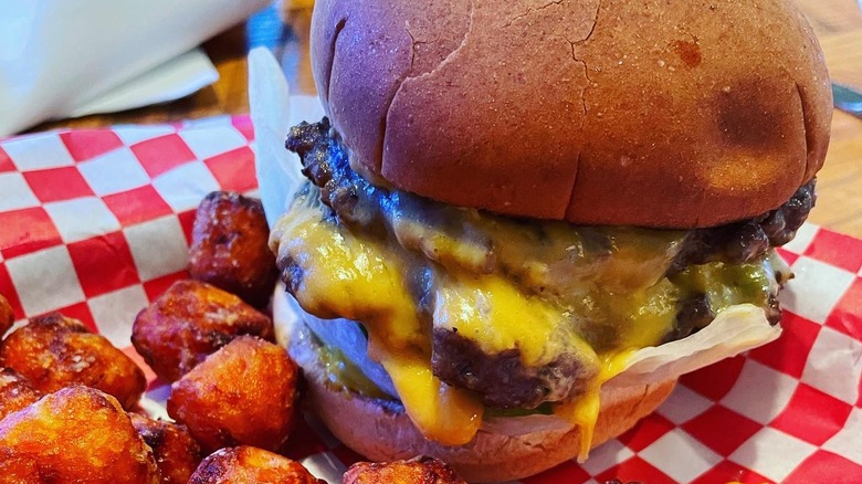 Burger and tots in checkered paper