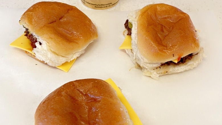 cheeseburgers on white countertop