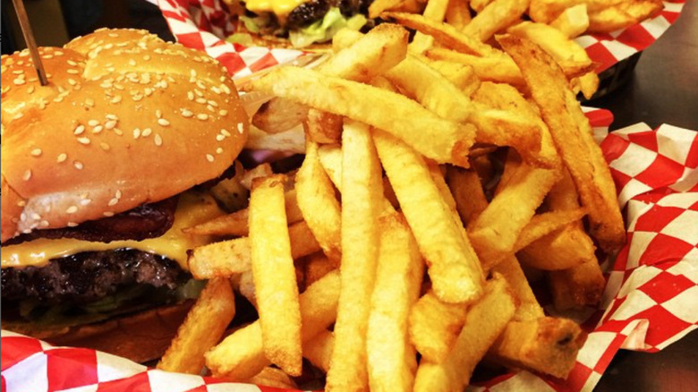 Meaty burger with cheese and fries