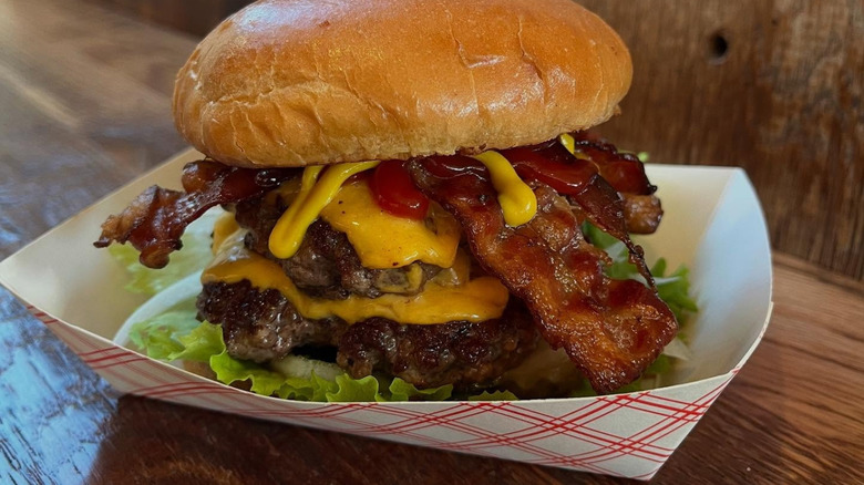 Double bacon burger in paper basket