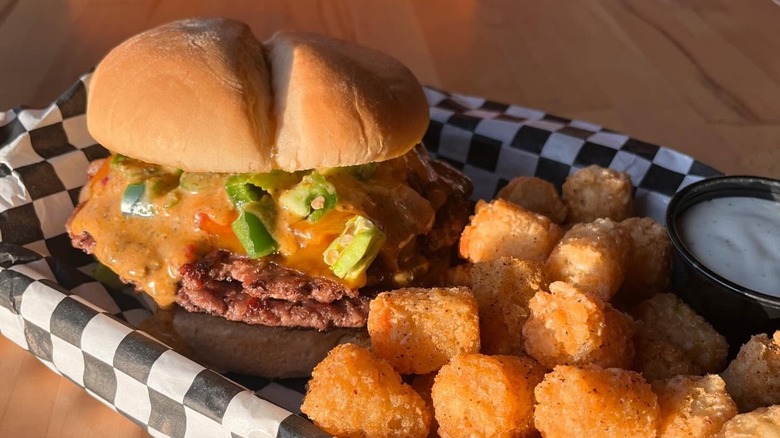 Burger with peppers on checkered paper