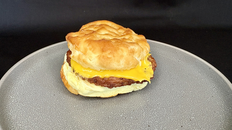 Burger King sausage, egg, and cheese biscuit on grey plate.