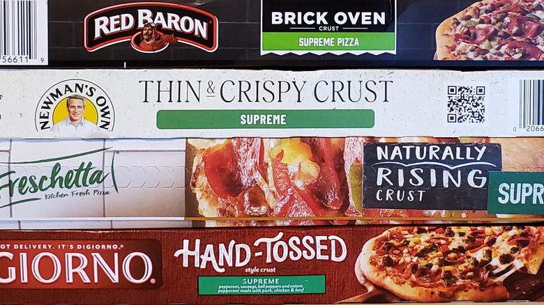 Assorted frozen pizza boxes.