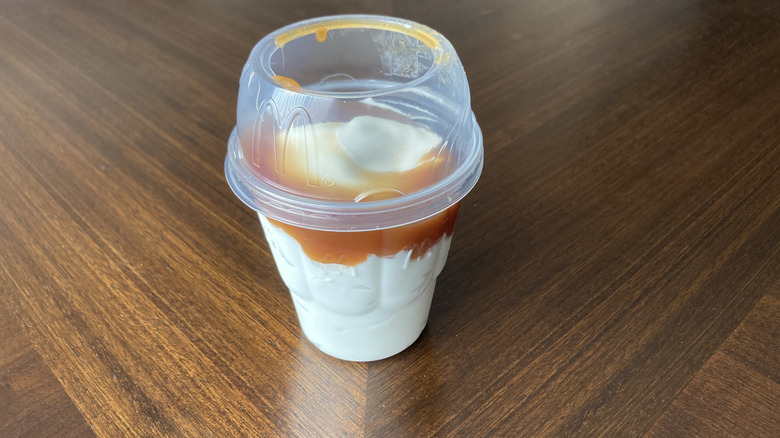 McDonald's hot caramel sundae on wooden table