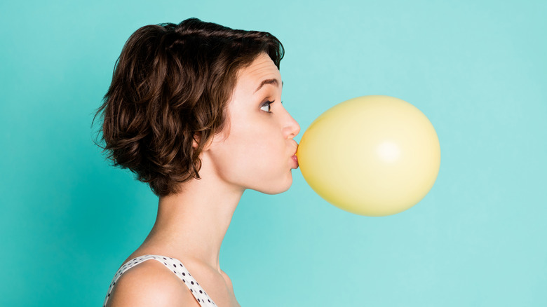 A woman blowing a big bubble