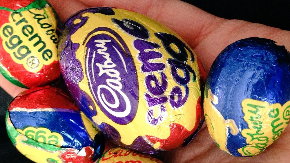 Hand holding Cadbury Creme Eggs