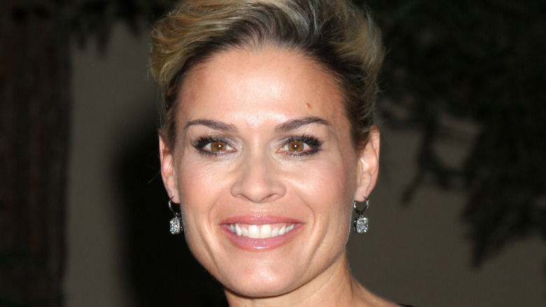 Cat Cora wearing diamond earrings