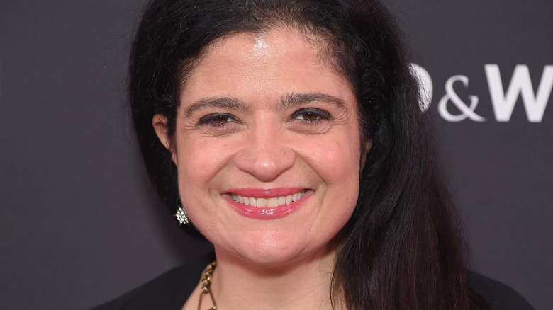 Alex Guarnaschelli smiles with pink lipgloss