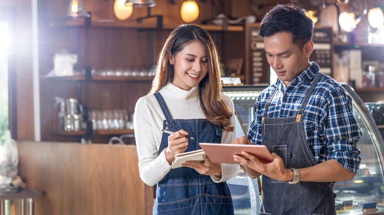 Happy café owners sharing notes