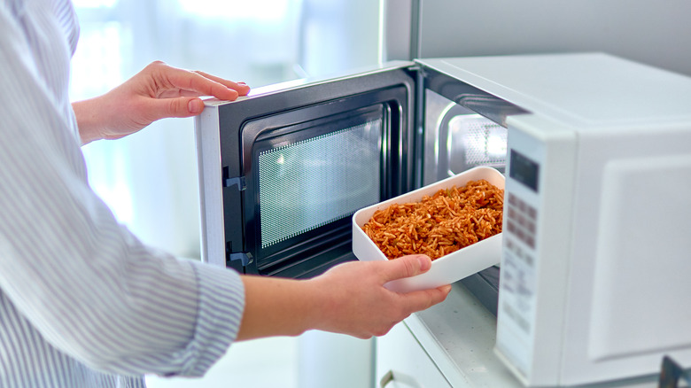 putting food into a microwave