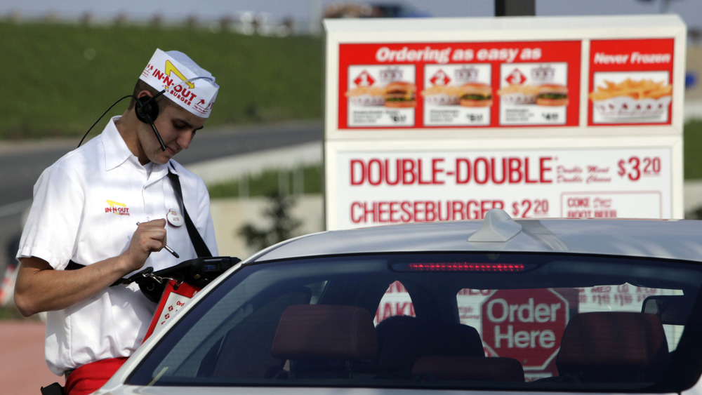 In-N-Out worker takes a drive-thru order