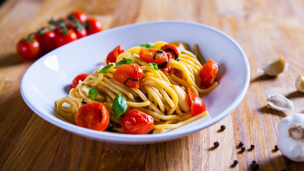 bowl of pasta with tomatoes and basil