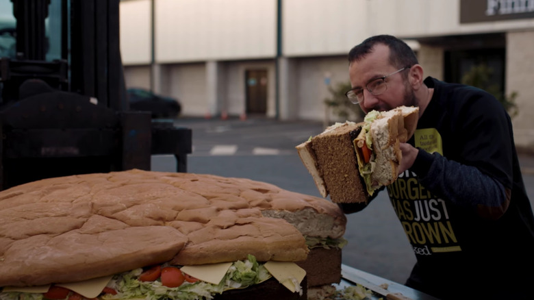 Man eating massive vegan burger