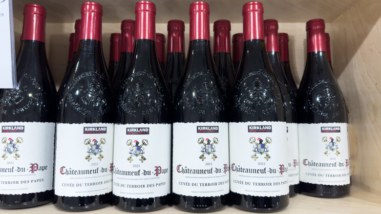 Bottles of Kirkland Signature Châteauneuf-du-Pape on shelf.