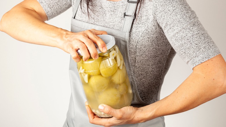 Woman trying to open a jar