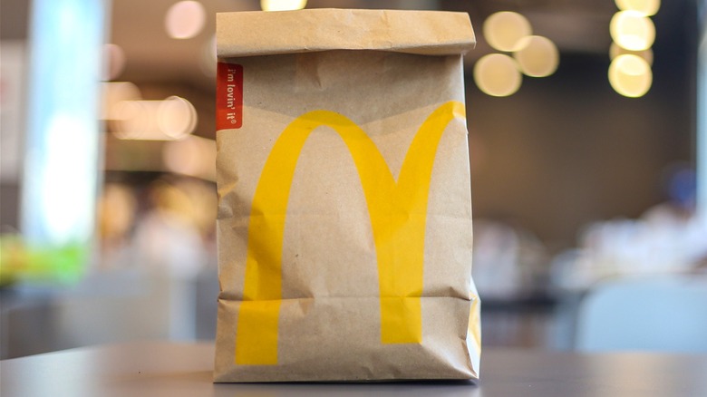 A McDonald's takeout bag inside the store.