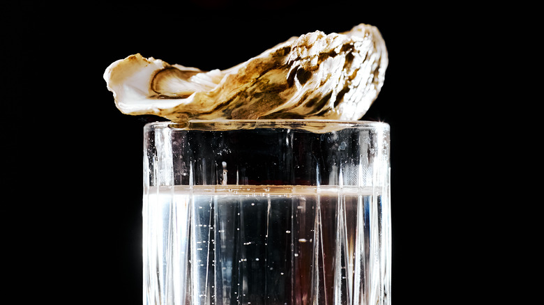 oyster on top of glass of vodka