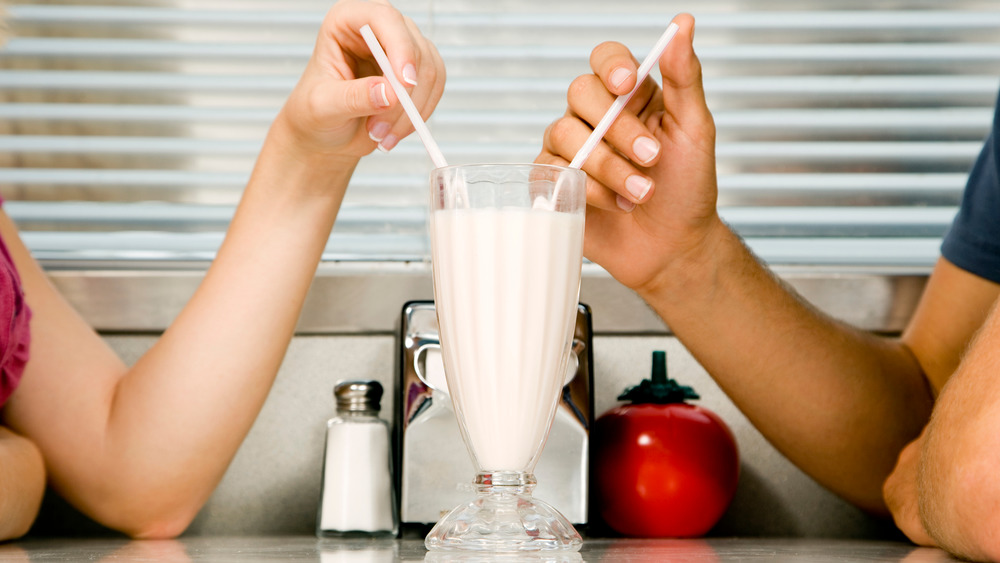 Couple sharing a milkshake