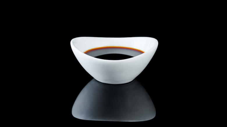 White bowl of soy sauce