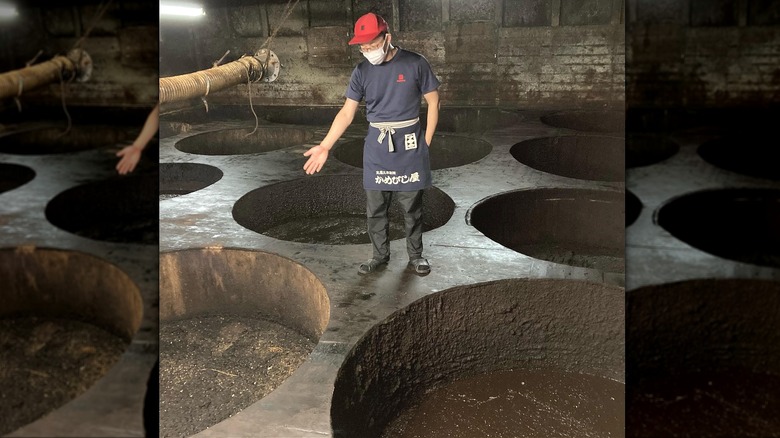 Kamebishi worker showing cedar vats