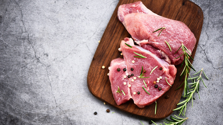 Pork steaks on cutting board