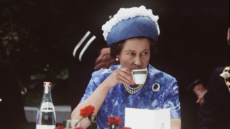 Queen Elizabeth drinking tea